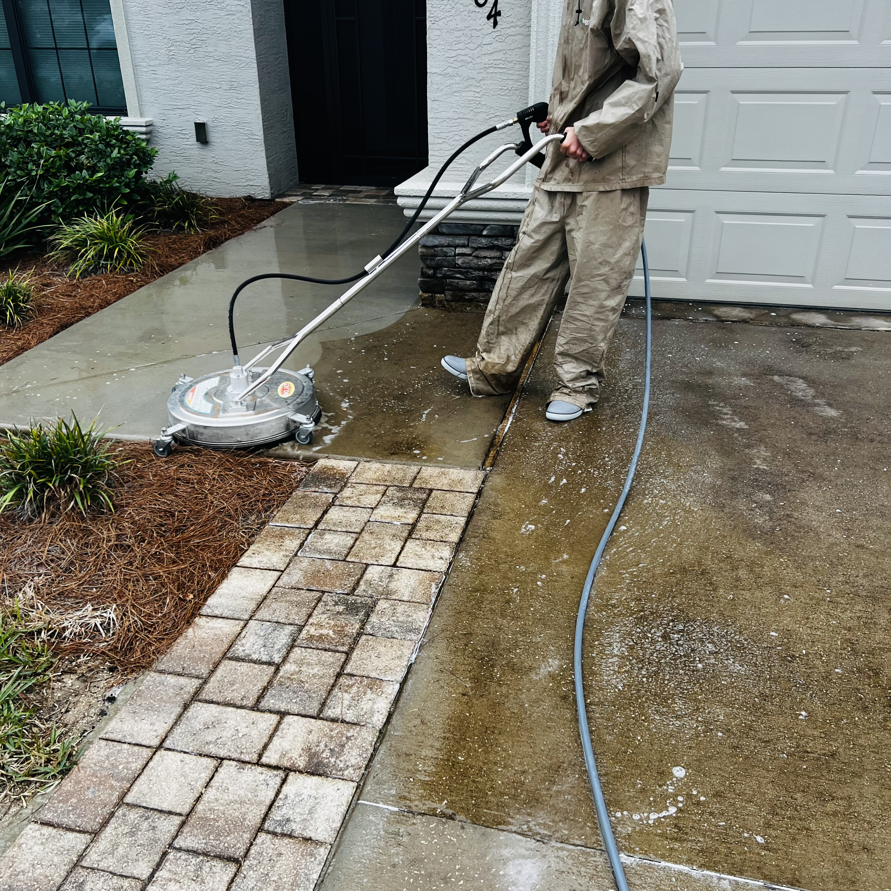 Brackell Pressure Washing 2 Pressure washing a residential driveway and walkway in Hernando, FL using a commercial surface cleaner by Brackell Pressure Washing & Soft Washing.